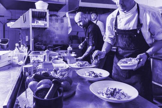 Cloud kitchen team plating dishes